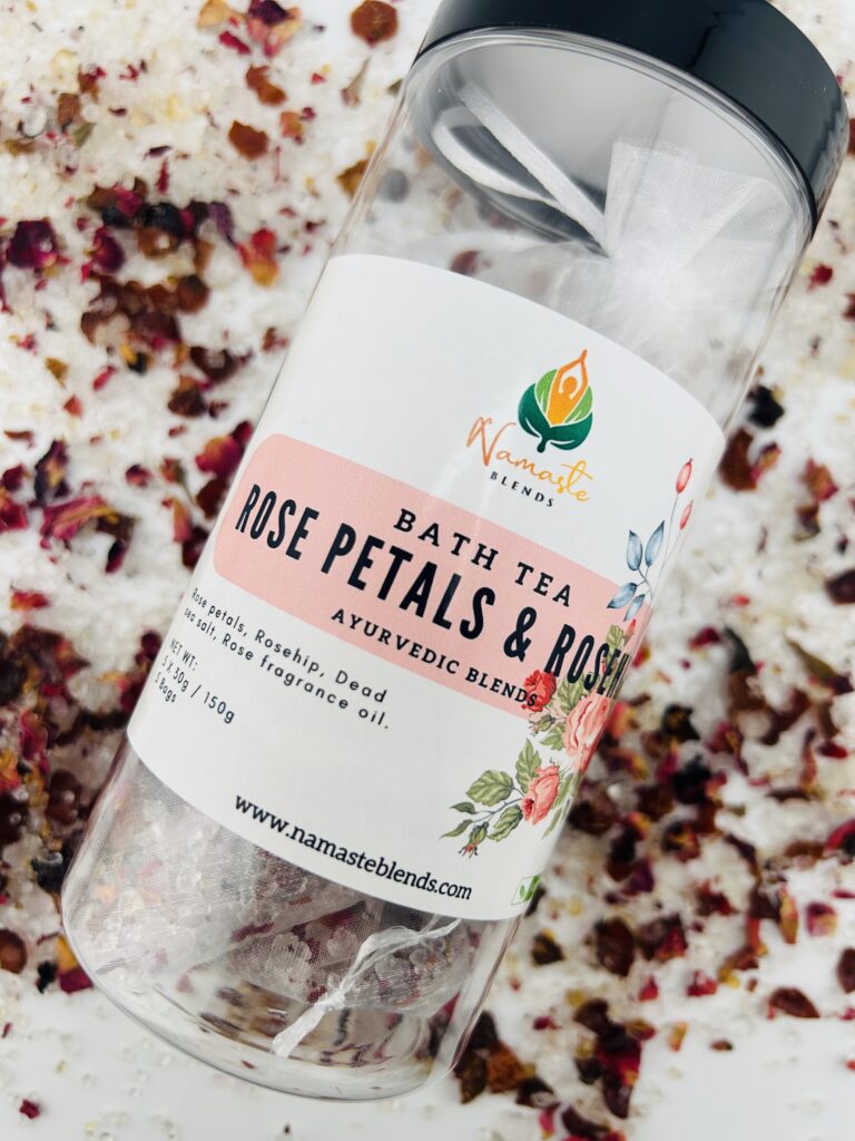 A close-up of a beautifully crafted Rose Petals Bath Sachet, featuring a delicate blend of dried rose petals and herbs in a breathable fabric pouch. The sachet exudes elegance, perfect for a soothing bath experience. It is placed on a white background, highlighting its vibrant pink and red hues.