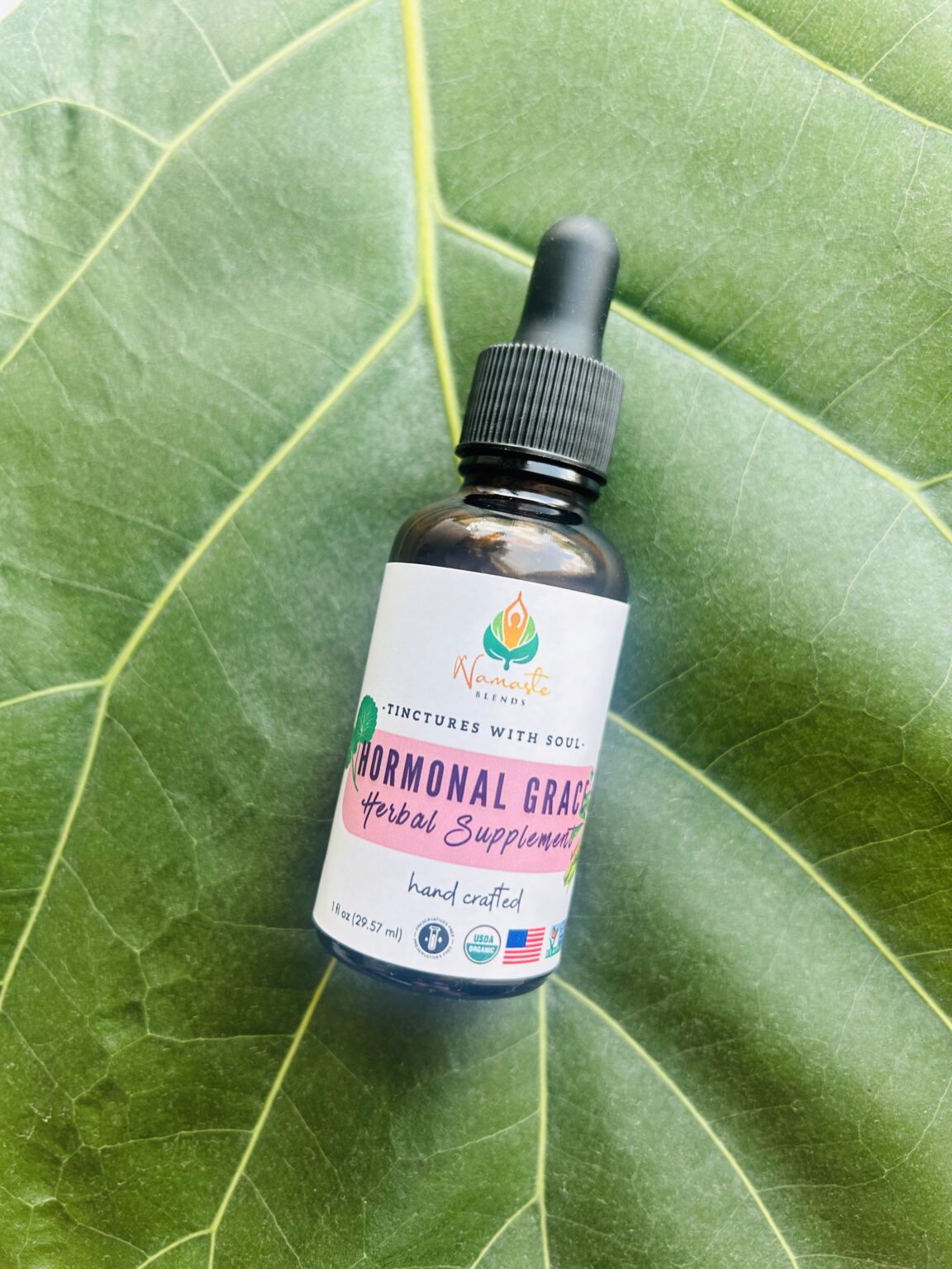 Bottle of Hormonal Grace Herbal Supplement, made with balancing herbs and food-grade alcohol to support hormonal harmony, emotional well-being, and menstrual health.