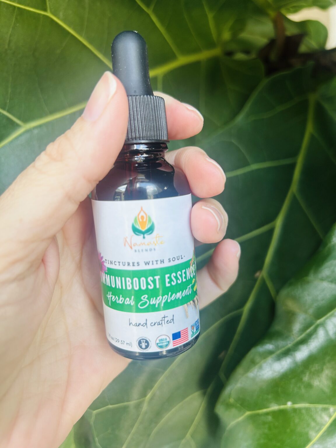 Bottle of ImmuniBoost Essence Herbal Supplement with immune-supporting herbs, designed to strengthen natural defenses and promote overall wellness.