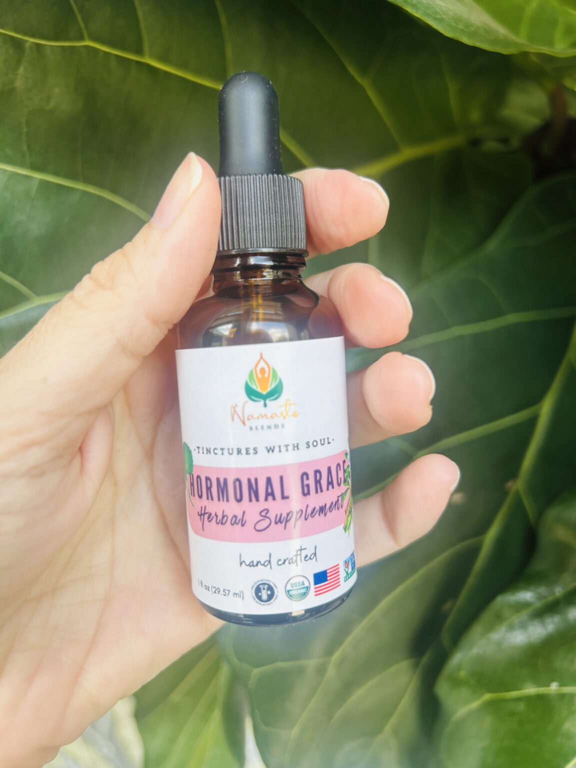 Bottle of Hormonal Grace Herbal Supplement, made with balancing herbs and food-grade alcohol to support hormonal harmony, emotional well-being, and menstrual health.