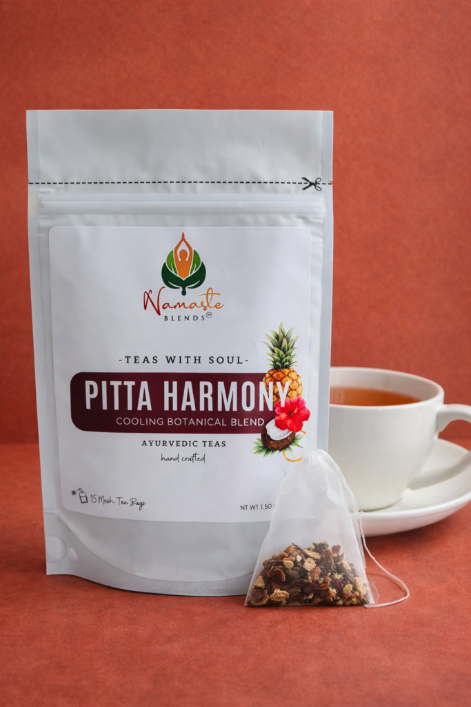 pitta harmony herbal tea bags displayed in a minimalist setting with a white mug and soft neutral tones, caffeine free herbal tea sachets with visible floral botanicals like hibiscus and rose, cooling herbal blend designed for daily wellness rituals and mindful living, cozy tea aesthetic, herbal tea for calm and balance, wellness tea gift idea, tea bags presentation for self care and refreshing routine