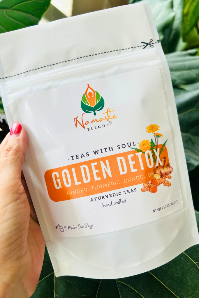 loose leaf golden detox herbal tea displayed in a minimalist setting with a white mug and warm neutral tones, caffeine free herbal tea with visible dried botanicals designed for daily cleansing rituals and balanced wellness routine, natural loose leaf tea blend for mindful living and reset habits, cozy tea aesthetic, herbal tea for daily detox routine, wellness tea gift idea, loose leaf tea pouch presentation for self care and balanced lifestyle