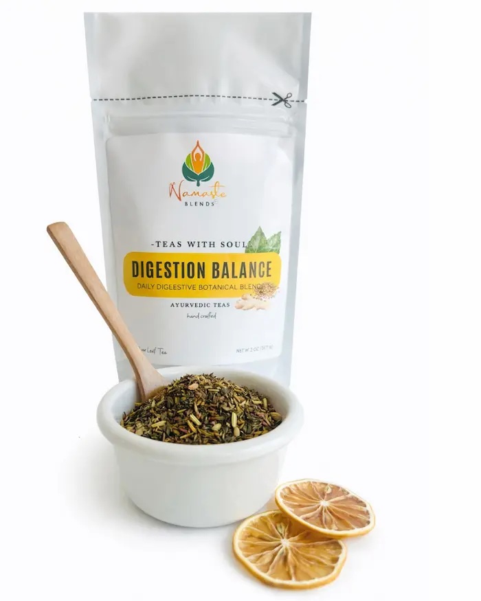 Loose leaf herbal tea for digestion balance displayed in a minimalist setting with a white mug and neutral background, caffeine free herbal tea with visible dried roots and botanicals designed for daily digestive wellness rituals, natural loose leaf tea blend for mindful living and gentle routine support, cozy tea aesthetic, herbal tea for gut balance lifestyle, wellness tea gift idea, loose leaf tea pouch presentation for self care and balanced daily habits