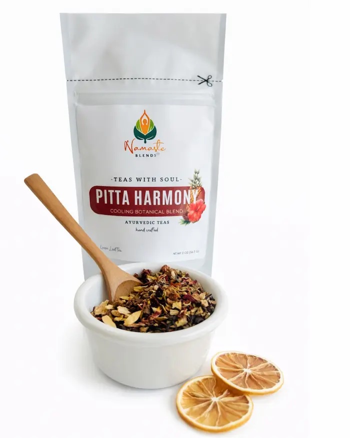 Loose leaf herbal tea for Pitta balance displayed in a minimalist setting with a white mug and soft neutral tones, caffeine free herbal tea with visible dried botanicals designed for cooling daily wellness rituals, refreshing loose leaf tea blend for calm and balance routine, cozy tea aesthetic, herbal tea for soothing self care moments, wellness tea gift idea, loose leaf tea pouch presentation for mindful living and balanced lifestyle