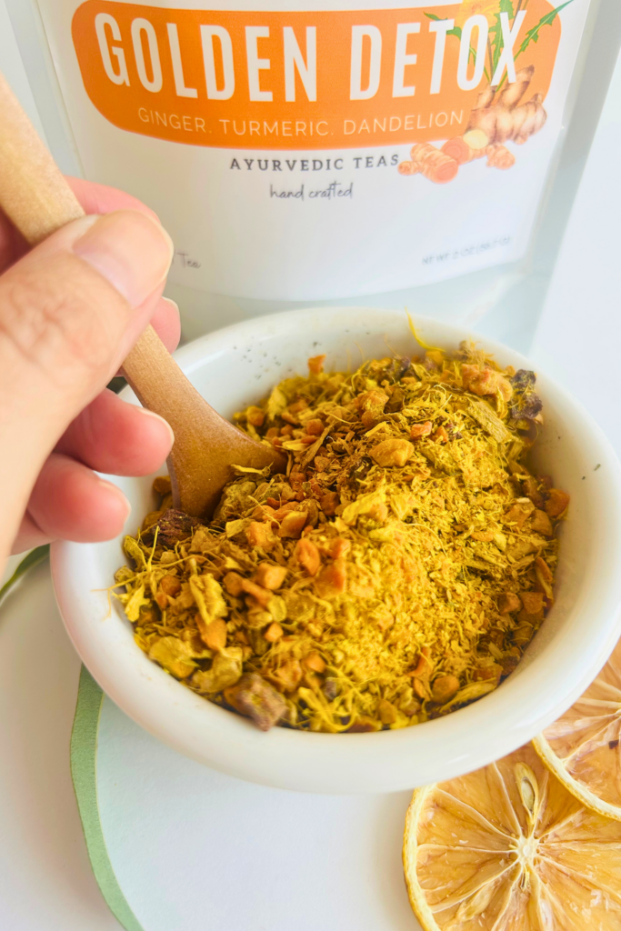 Loose leaf herbal detox tea blend with turmeric, ginger, beet, pineapple, calendula, and dandelion leaves in a botanical wellness tea designed for cozy daily rituals, digestion support, and mindful self care. Caffeine free loose leaf tea by Namaste Blends with earthy golden tones and warming ingredients.
