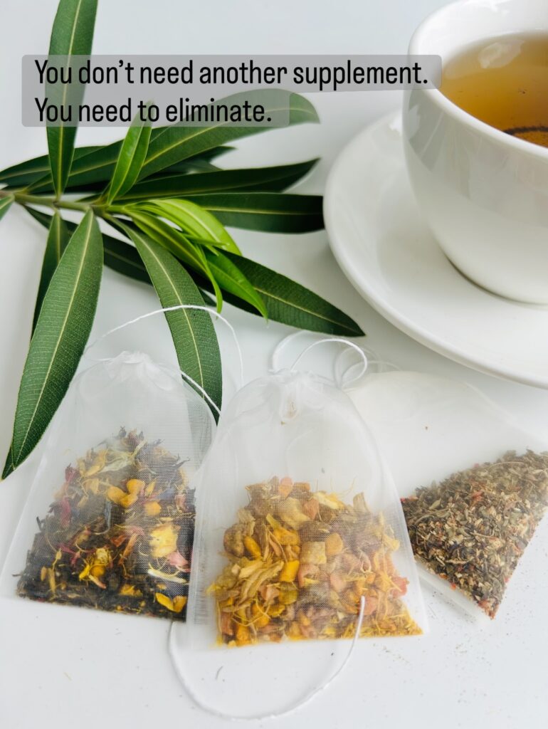 ginger turmeric herbal tea displayed in a minimalist setting with a white mug and warm neutral tones, caffeine free herbal tea with visible ginger pieces and turmeric root, warming botanical blend designed for daily wellness rituals and mindful living, cozy tea aesthetic, herbal tea for comfort and balance routine, wellness tea gift idea, tea presentation for self care and grounding daily habits