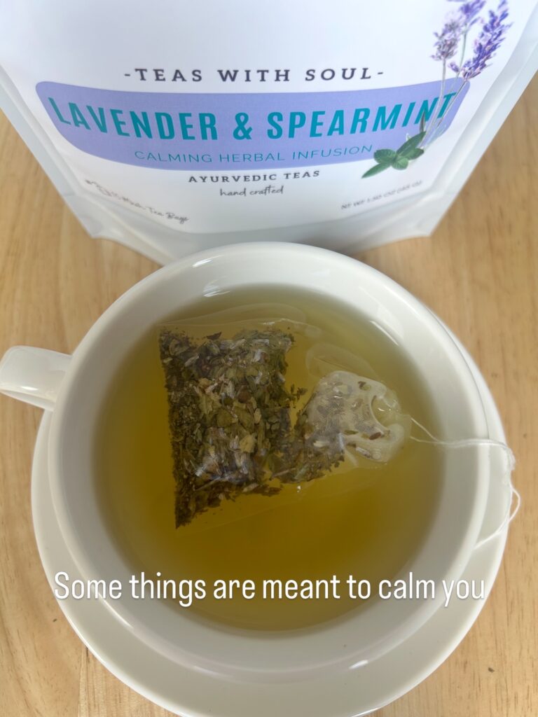 lavender spearmint herbal tea displayed in a minimalist setting with a white mug and soft neutral tones, organic caffeine free herbal tea with visible lavender buds and spearmint leaves, calming floral mint blend designed for daily wellness rituals and mindful living, cozy tea aesthetic, herbal tea for relaxation and balance, wellness tea gift idea, tea presentation for self care and peaceful lifestyle