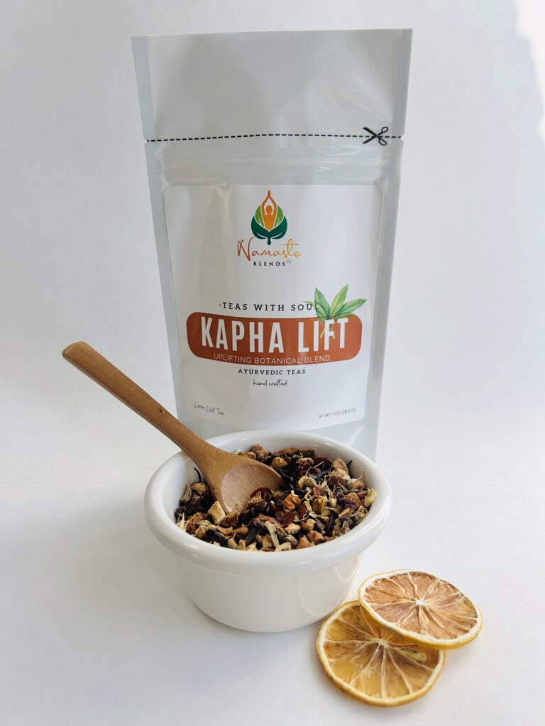 kapha lift herbal tea bags displayed in a minimalist setting with a white mug and warm neutral tones, caffeine free herbal tea sachets with visible spices like ginger clove and citrus pieces, energizing botanical blend designed for daily wellness rituals and mindful living, cozy tea aesthetic, herbal tea for energy and balance routine, wellness tea gift idea, tea bags presentation for self care and uplifting lifestyle