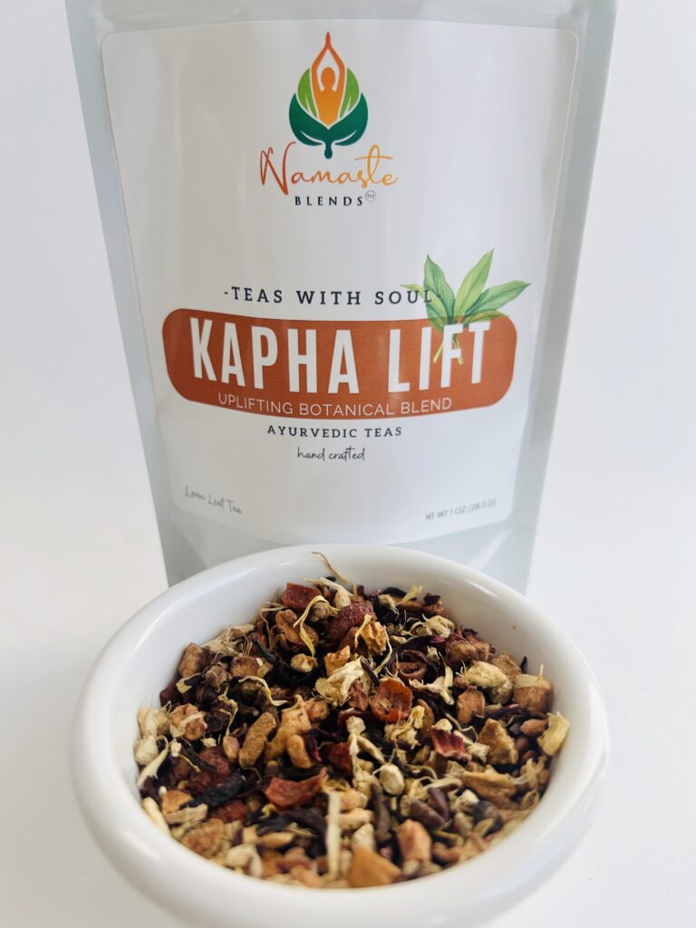 kapha lift herbal tea bags displayed in a minimalist setting with a white mug and warm neutral tones, caffeine free herbal tea sachets with visible spices like ginger clove and citrus pieces, energizing botanical blend designed for daily wellness rituals and mindful living, cozy tea aesthetic, herbal tea for energy and balance routine, wellness tea gift idea, tea bags presentation for self care and uplifting lifestyle