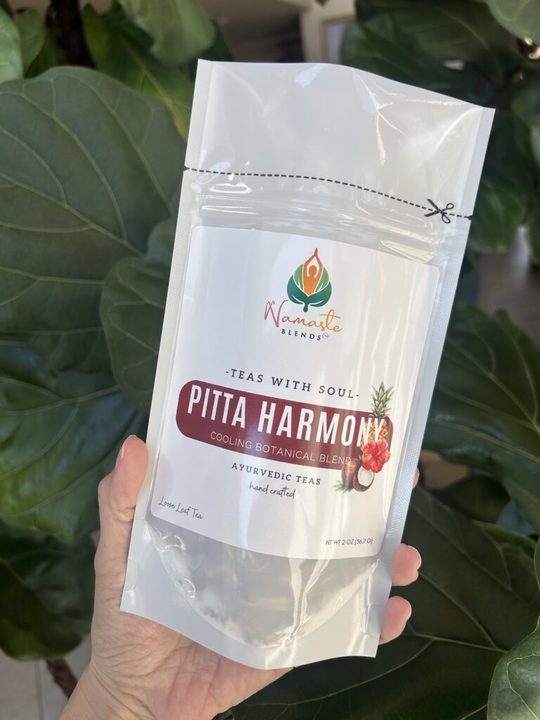 pitta harmony herbal tea bags displayed in a minimalist setting with a white mug and soft neutral tones, caffeine free herbal tea sachets with visible floral botanicals like hibiscus and rose, cooling herbal blend designed for daily wellness rituals and mindful living, cozy tea aesthetic, herbal tea for calm and balance, wellness tea gift idea, tea bags presentation for self care and refreshing routine