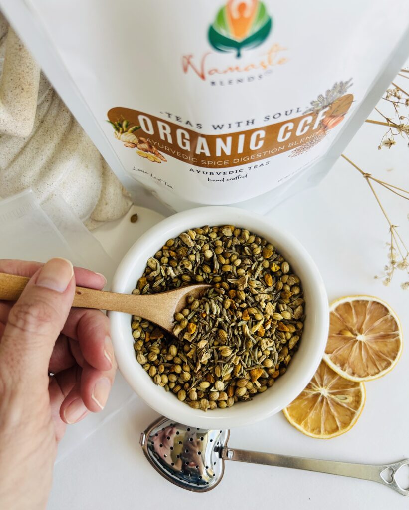 organic ccf herbal tea displayed in a minimalist setting with a white mug and neutral background, caffeine free tea with visible cumin coriander and fennel seeds, traditional ayurvedic herbal blend designed for daily digestive wellness rituals and mindful living, cozy tea aesthetic, natural herbal tea for balance and gentle routine support, wellness tea gift idea, tea presentation for self care and balanced lifestyle