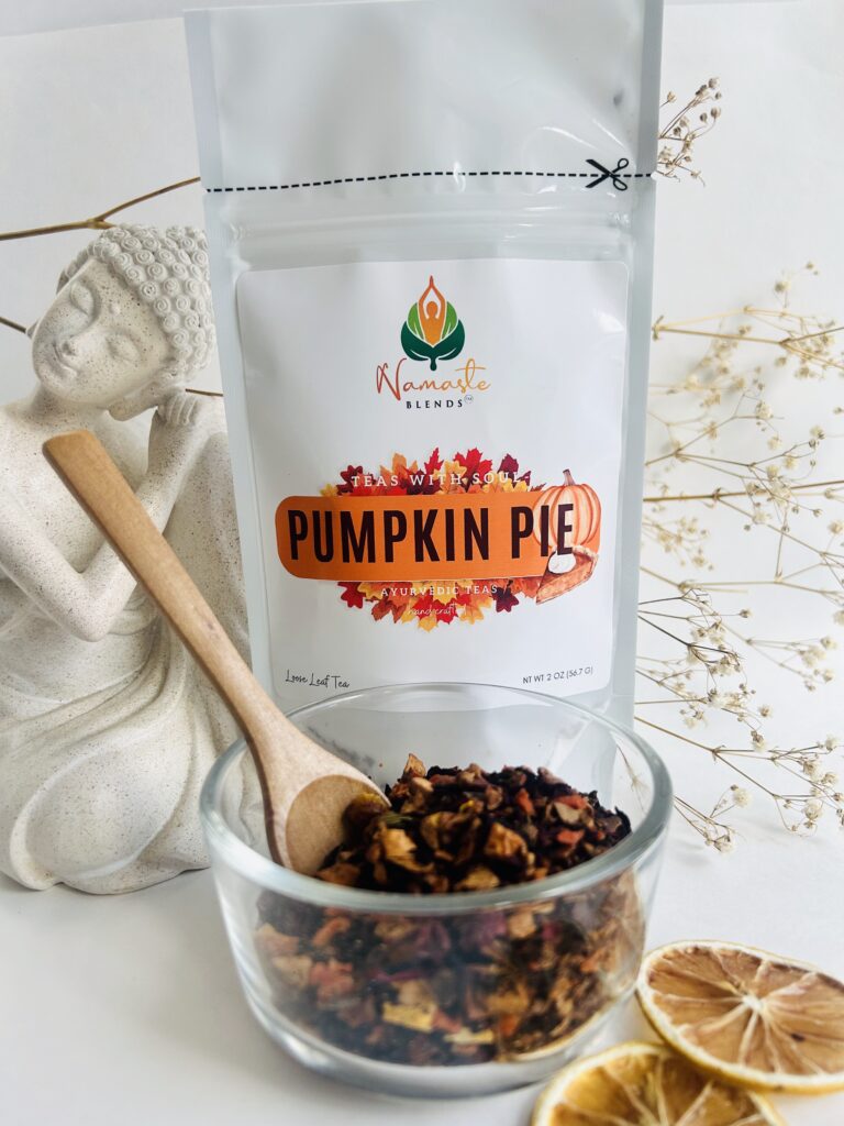 pumpkin pie herbal tea displayed in a minimalist setting with a white mug and warm neutral tones, caffeine free herbal tea with visible spices and pumpkin pieces, cozy spiced tea blend designed for daily wellness rituals and mindful living, fall tea aesthetic, herbal tea for comfort and warmth, wellness tea gift idea, tea presentation for self care and cozy lifestyle