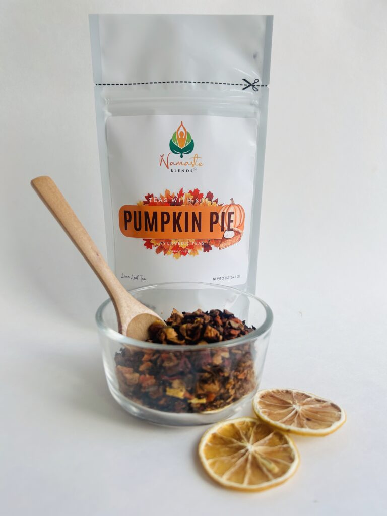 pumpkin pie herbal tea displayed in a minimalist setting with a white mug and warm neutral tones, caffeine free herbal tea with visible spices and pumpkin pieces, cozy spiced tea blend designed for daily wellness rituals and mindful living, fall tea aesthetic, herbal tea for comfort and warmth, wellness tea gift idea, tea presentation for self care and cozy lifestyle