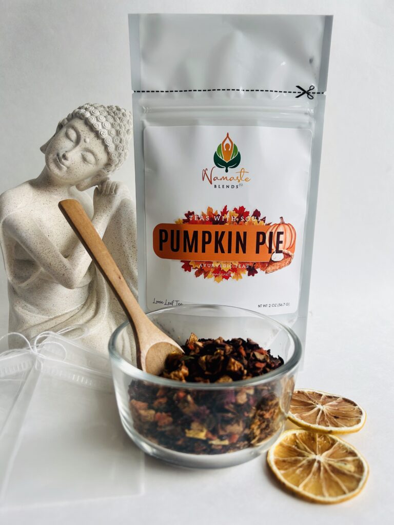 pumpkin pie herbal tea displayed in a minimalist setting with a white mug and warm neutral tones, caffeine free herbal tea with visible spices and pumpkin pieces, cozy spiced tea blend designed for daily wellness rituals and mindful living, fall tea aesthetic, herbal tea for comfort and warmth, wellness tea gift idea, tea presentation for self care and cozy lifestyle