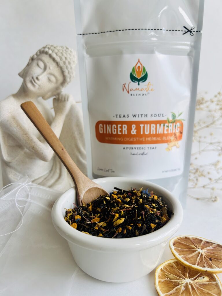 ginger turmeric herbal tea displayed in a minimalist setting with a white mug and warm neutral tones, caffeine free herbal tea with visible ginger pieces and turmeric root, warming botanical blend designed for daily wellness rituals and mindful living, cozy tea aesthetic, herbal tea for comfort and balance routine, wellness tea gift idea, tea presentation for self care and grounding daily habits