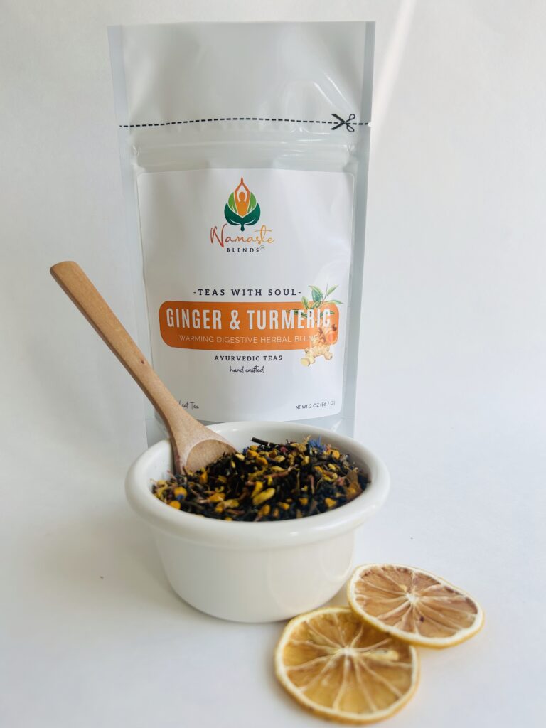 ginger turmeric herbal tea displayed in a minimalist setting with a white mug and warm neutral tones, caffeine free herbal tea with visible ginger pieces and turmeric root, warming botanical blend designed for daily wellness rituals and mindful living, cozy tea aesthetic, herbal tea for comfort and balance routine, wellness tea gift idea, tea presentation for self care and grounding daily habits