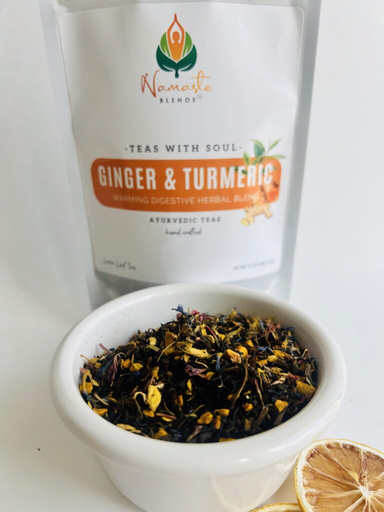 ginger turmeric herbal tea displayed in a minimalist setting with a white mug and warm neutral tones, caffeine free herbal tea with visible ginger pieces and turmeric root, warming botanical blend designed for daily wellness rituals and mindful living, cozy tea aesthetic, herbal tea for comfort and balance routine, wellness tea gift idea, tea presentation for self care and grounding daily habits