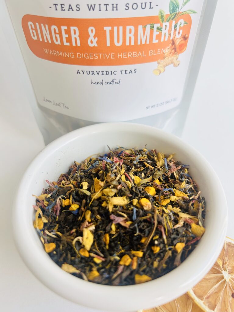 ginger turmeric herbal tea displayed in a minimalist setting with a white mug and warm neutral tones, caffeine free herbal tea with visible ginger pieces and turmeric root, warming botanical blend designed for daily wellness rituals and mindful living, cozy tea aesthetic, herbal tea for comfort and balance routine, wellness tea gift idea, tea presentation for self care and grounding daily habits