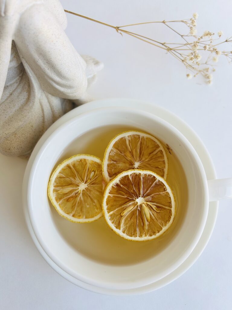 dried orange slices displayed in a minimalist setting with a white mug and neutral background, natural citrus slices for enhancing herbal tea, tea garnish for loose leaf and tea bags, cozy tea aesthetic, dried fruit slices for self care routine and mindful living, tea accessory for daily rituals, orange slices presentation for tea essentials and balanced lifestyle