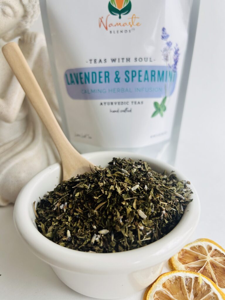 lavender spearmint herbal tea displayed in a minimalist setting with a white mug and soft neutral tones, organic caffeine free herbal tea with visible lavender buds and spearmint leaves, calming floral mint blend designed for daily wellness rituals and mindful living, cozy tea aesthetic, herbal tea for relaxation and balance, wellness tea gift idea, tea presentation for self care and peaceful lifestyle