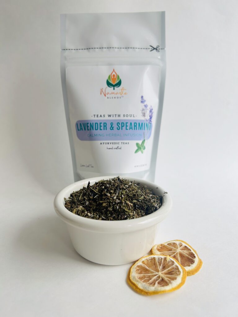 lavender spearmint herbal tea displayed in a minimalist setting with a white mug and soft neutral tones, organic caffeine free herbal tea with visible lavender buds and spearmint leaves, calming floral mint blend designed for daily wellness rituals and mindful living, cozy tea aesthetic, herbal tea for relaxation and balance, wellness tea gift idea, tea presentation for self care and peaceful lifestyle