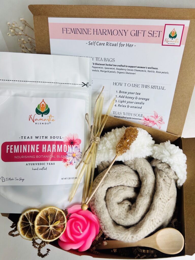 feminine support gift box displayed in a minimalist setting with a white mug and soft neutral tones, curated self care set featuring herbal tea bags, candle, cozy socks and sugar sticks, calming wellness box for women, relaxation gift aesthetic, cozy self care ritual set for comfort and balance, wellness gift presentation for nurturing routine and mindful living