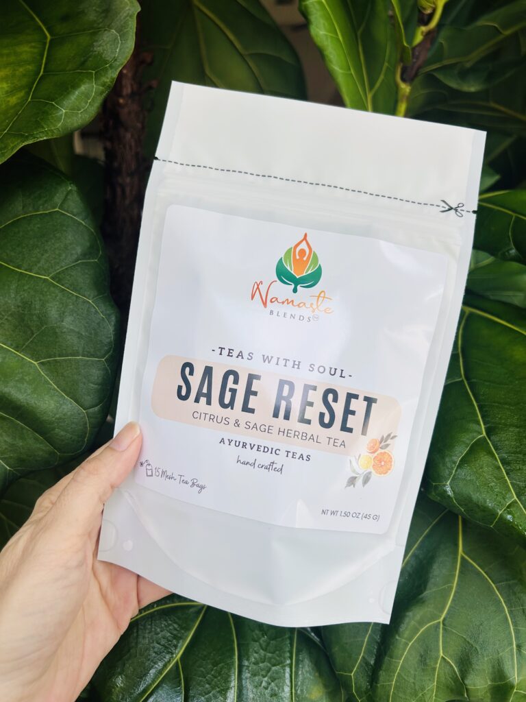 sage reset herbal tea bags displayed in a minimalist setting with a white mug and soft neutral tones, caffeine free herbal tea sachets with visible citrus pieces and sage leaves, refreshing botanical blend designed for daily wellness rituals and mindful living, cozy tea aesthetic, herbal tea for clarity and balance, wellness tea gift idea, tea bags presentation for self care and refreshing routine