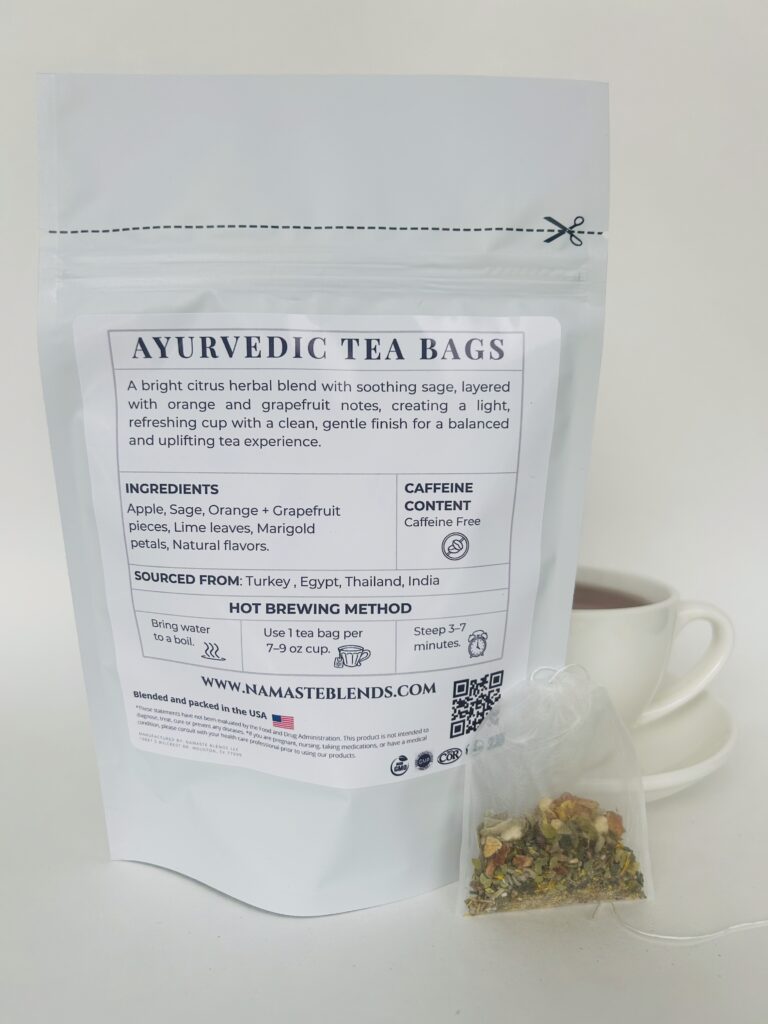 sage reset herbal tea bags displayed in a minimalist setting with a white mug and soft neutral tones, caffeine free herbal tea sachets with visible citrus pieces and sage leaves, refreshing botanical blend designed for daily wellness rituals and mindful living, cozy tea aesthetic, herbal tea for clarity and balance, wellness tea gift idea, tea bags presentation for self care and refreshing routine