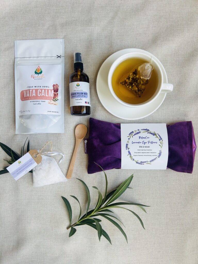 self care gift box displayed in a minimalist setting with a white mug and soft neutral tones, curated wellness set featuring herbal tea bags, lavender eye pillow, pillow mist, magnesium bath flakes and wooden spoon, calming spa gift aesthetic, relaxation gift box for stress relief and mindful living, cozy self care ritual set, wellness gift presentation for comfort and peaceful lifestyle