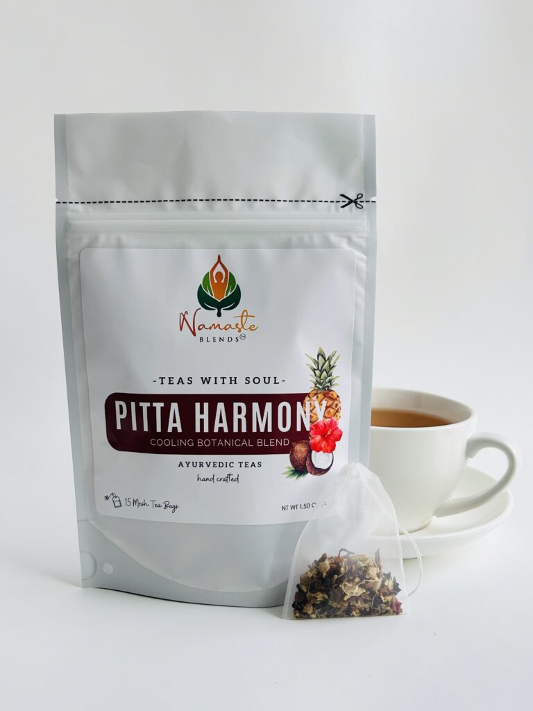 pitta harmony herbal tea bags displayed in a minimalist setting with a white mug and soft neutral tones, caffeine free herbal tea sachets with visible floral botanicals like hibiscus and rose, cooling herbal blend designed for daily wellness rituals and mindful living, cozy tea aesthetic, herbal tea for calm and balance, wellness tea gift idea, tea bags presentation for self care and refreshing routine