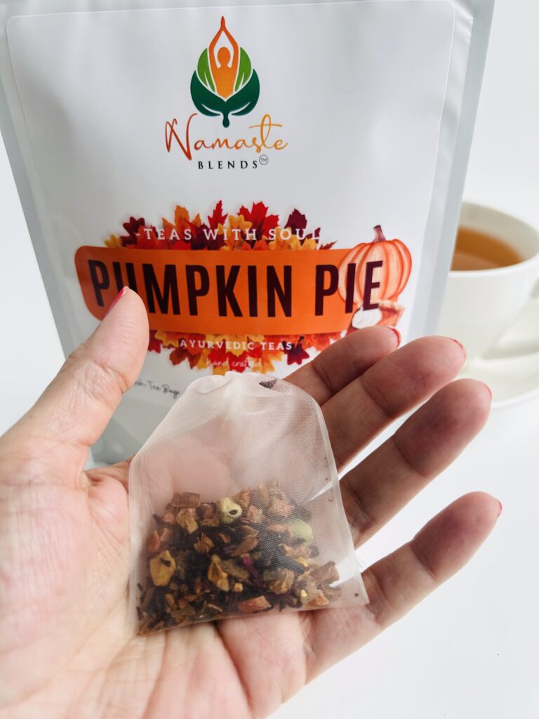 pumpkin pie herbal tea displayed in a minimalist setting with a white mug and warm neutral tones, caffeine free herbal tea with visible spices and pumpkin pieces, cozy spiced tea blend designed for daily wellness rituals and mindful living, fall tea aesthetic, herbal tea for comfort and warmth, wellness tea gift idea, tea presentation for self care and cozy lifestyle
