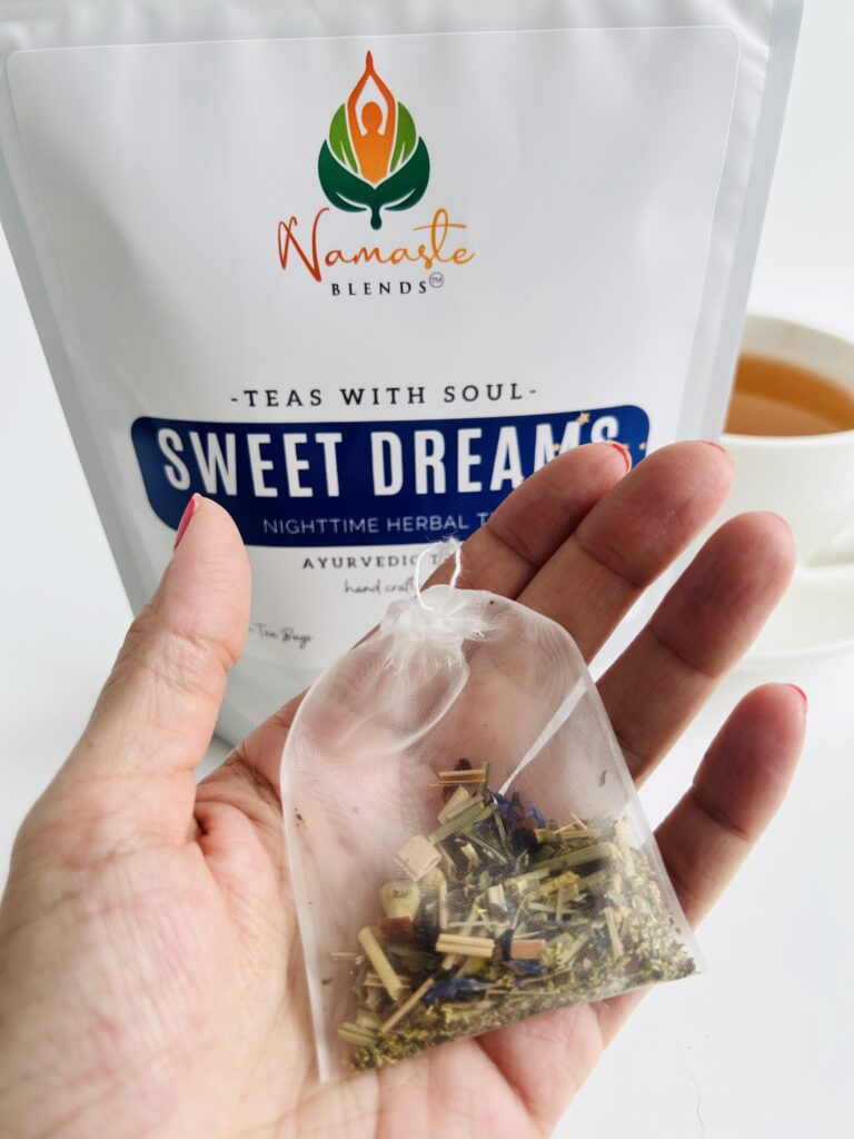 sweet dreams herbal tea bags displayed in a minimalist setting with a white mug and soft neutral tones, caffeine free herbal tea sachets with visible botanicals like chamomile and lemongrass, calming night blend designed for evening wellness rituals and mindful living, cozy tea aesthetic, herbal tea for relaxation and rest routine, wellness tea gift idea, tea bags presentation for self care and peaceful lifestyle