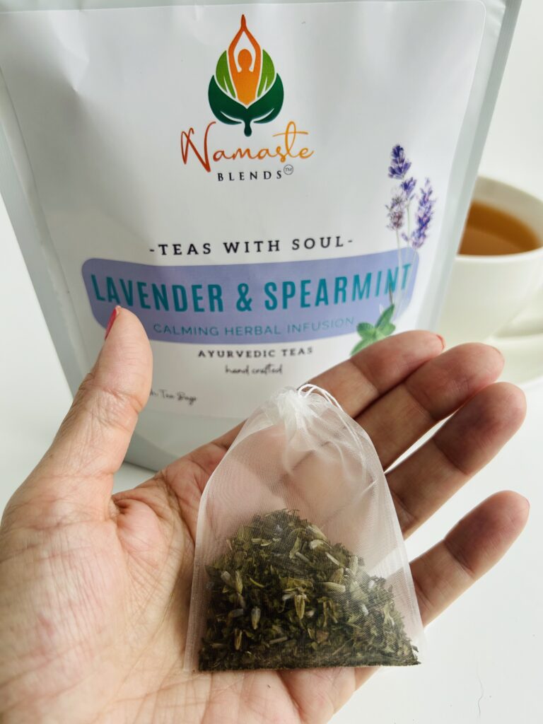 lavender spearmint herbal tea displayed in a minimalist setting with a white mug and soft neutral tones, organic caffeine free herbal tea with visible lavender buds and spearmint leaves, calming floral mint blend designed for daily wellness rituals and mindful living, cozy tea aesthetic, herbal tea for relaxation and balance, wellness tea gift idea, tea presentation for self care and peaceful lifestyle