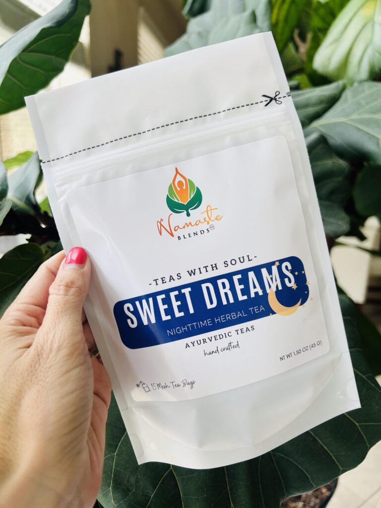 sweet dreams herbal tea bags displayed in a minimalist setting with a white mug and soft neutral tones, caffeine free herbal tea sachets with visible botanicals like chamomile and lemongrass, calming night blend designed for evening wellness rituals and mindful living, cozy tea aesthetic, herbal tea for relaxation and rest routine, wellness tea gift idea, tea bags presentation for self care and peaceful lifestyle