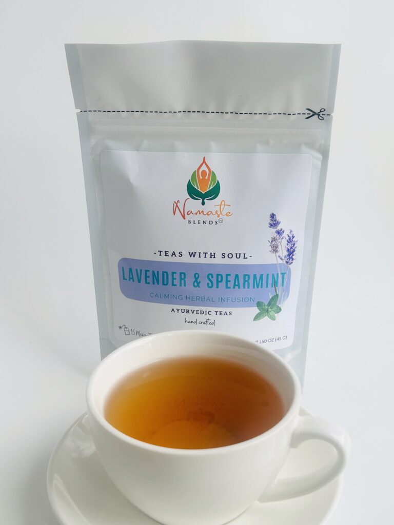 lavender spearmint herbal tea displayed in a minimalist setting with a white mug and soft neutral tones, organic caffeine free herbal tea with visible lavender buds and spearmint leaves, calming floral mint blend designed for daily wellness rituals and mindful living, cozy tea aesthetic, herbal tea for relaxation and balance, wellness tea gift idea, tea presentation for self care and peaceful lifestyle