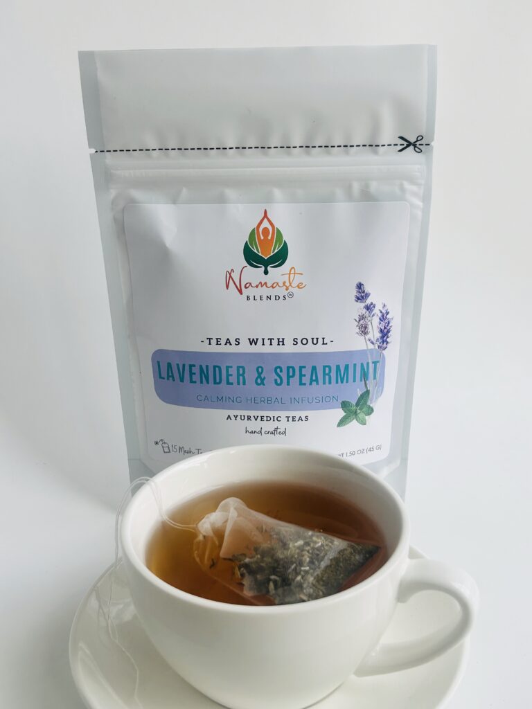 lavender spearmint herbal tea displayed in a minimalist setting with a white mug and soft neutral tones, organic caffeine free herbal tea with visible lavender buds and spearmint leaves, calming floral mint blend designed for daily wellness rituals and mindful living, cozy tea aesthetic, herbal tea for relaxation and balance, wellness tea gift idea, tea presentation for self care and peaceful lifestyle