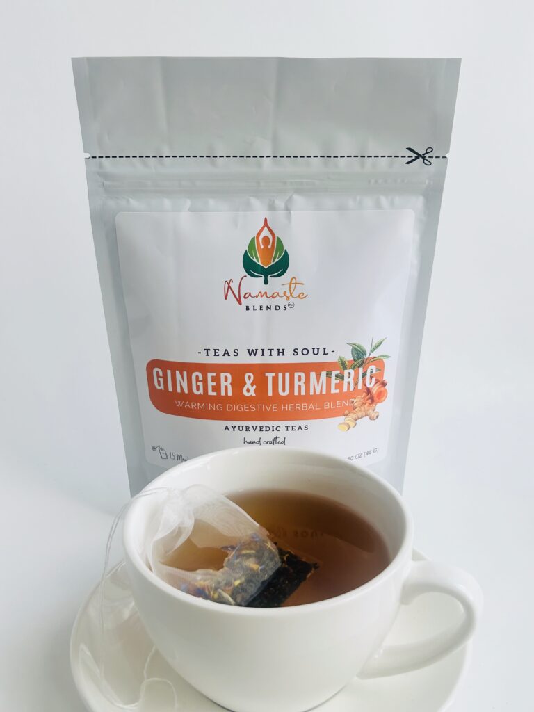 ginger turmeric herbal tea displayed in a minimalist setting with a white mug and warm neutral tones, caffeine free herbal tea with visible ginger pieces and turmeric root, warming botanical blend designed for daily wellness rituals and mindful living, cozy tea aesthetic, herbal tea for comfort and balance routine, wellness tea gift idea, tea presentation for self care and grounding daily habits