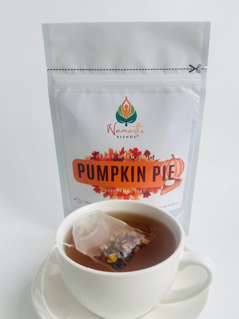 pumpkin pie herbal tea displayed in a minimalist setting with a white mug and warm neutral tones, caffeine free herbal tea with visible spices and pumpkin pieces, cozy spiced tea blend designed for daily wellness rituals and mindful living, fall tea aesthetic, herbal tea for comfort and warmth, wellness tea gift idea, tea presentation for self care and cozy lifestyle