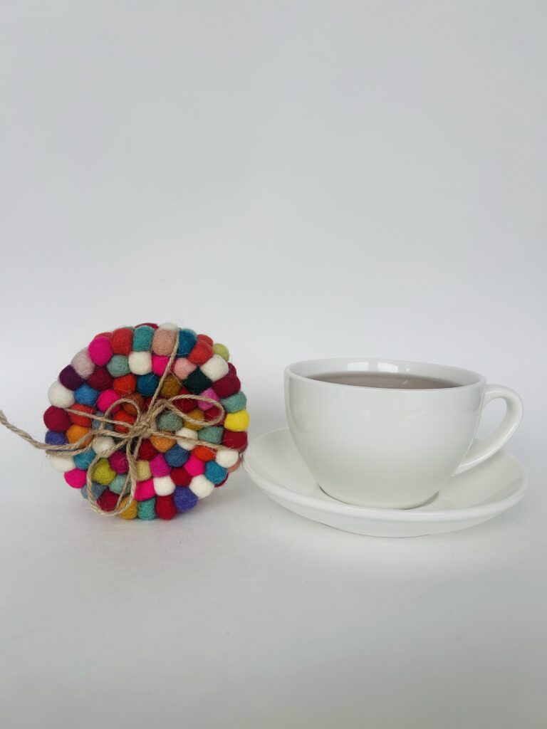 floral felt ball coasters soft pom pom coasters set of 4 colorful flower coaster set tea cup coaster cozy tea setup table decor tea accessory soft coaster set for mugs handmade style coaster aesthetic tea ritual decor home decor tea lovers gift soft felt coaster set
