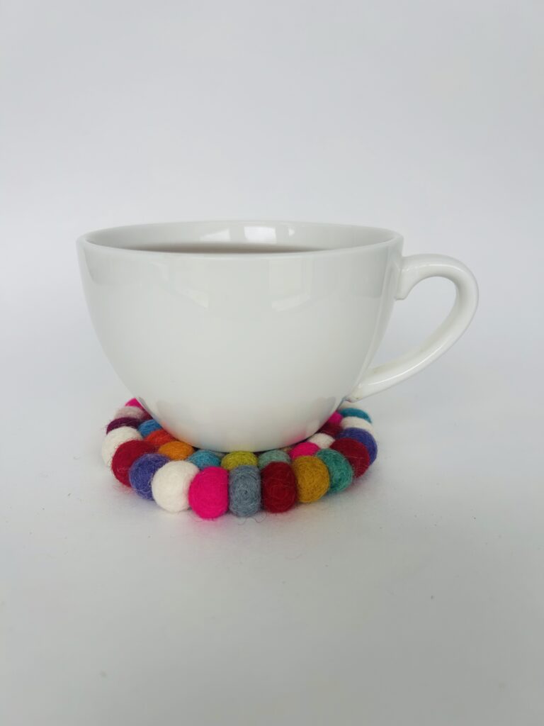 floral felt ball coasters soft pom pom coasters set of 4 colorful flower coaster set tea cup coaster cozy tea setup table decor tea accessory soft coaster set for mugs handmade style coaster aesthetic tea ritual decor home decor tea lovers gift soft felt coaster set