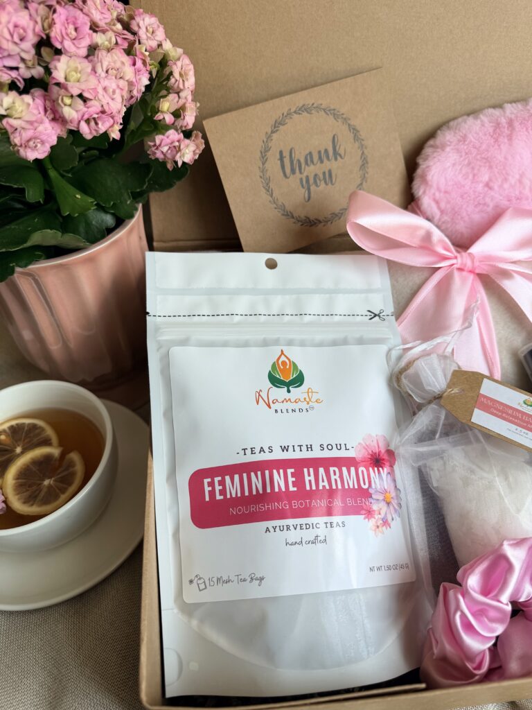 The Bloom Ritual Gift Box is a luxurious self-care gift designed to inspire peaceful moments of relaxation and everyday wellness. Featuring our handcrafted Feminine Harmony Herbal Tea, a cozy throw blanket, plush eye mask, satin scrunchie, magnesium bath flakes, Bloom pillow mist, ceramic tea mug, gold spoon, honey stick, and sugar stick, this beautifully curated collection transforms an ordinary tea break into a comforting self-care ritual. This premium gift set includes 15 food-grade mesh tea bags filled with our naturally caffeine-free botanical blend, handcrafted in small batches by Namaste Blends. Beautifully packaged and ready to gift, it's the perfect choice for birthdays, Mother's Day, Valentine's Day, bridal showers, holidays, or anyone who enjoys cozy tea moments, botanical wellness, and intentional self-care.