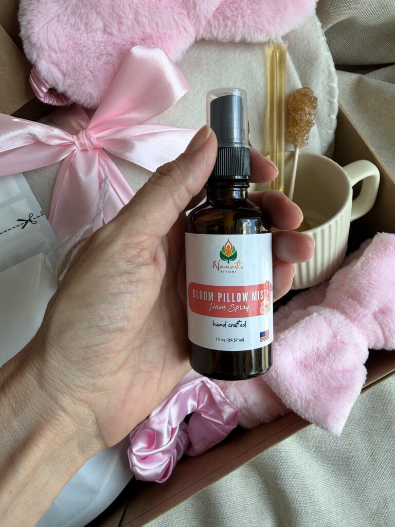 The Bloom Ritual Gift Box is a luxurious self-care gift designed to inspire peaceful moments of relaxation and everyday wellness. Featuring our handcrafted Feminine Harmony Herbal Tea, a cozy throw blanket, plush eye mask, satin scrunchie, magnesium bath flakes, Bloom pillow mist, ceramic tea mug, gold spoon, honey stick, and sugar stick, this beautifully curated collection transforms an ordinary tea break into a comforting self-care ritual. This premium gift set includes 15 food-grade mesh tea bags filled with our naturally caffeine-free botanical blend, handcrafted in small batches by Namaste Blends. Beautifully packaged and ready to gift, it's the perfect choice for birthdays, Mother's Day, Valentine's Day, bridal showers, holidays, or anyone who enjoys cozy tea moments, botanical wellness, and intentional self-care.