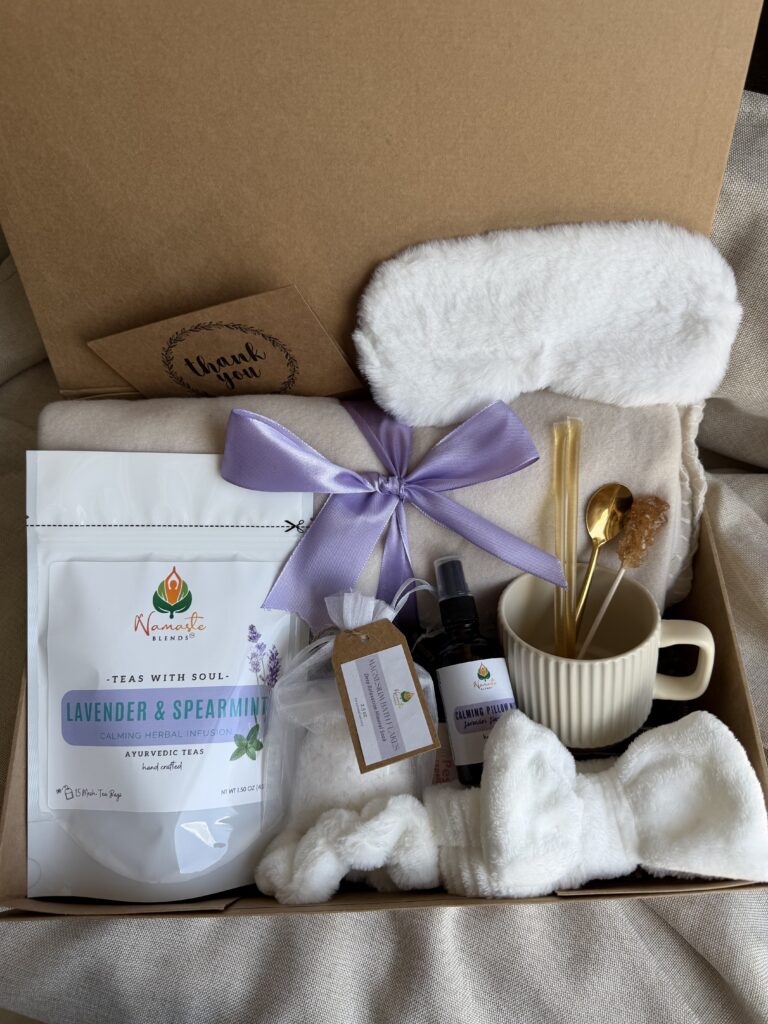 Serenity Ritual Gift Box featuring Lavender & Spearmint Herbal Tea, cozy blanket, plush eye mask, spa headband, magnesium bath flakes, calming pillow mist, ceramic tea mug, and self-care essentials by Namaste Blends.