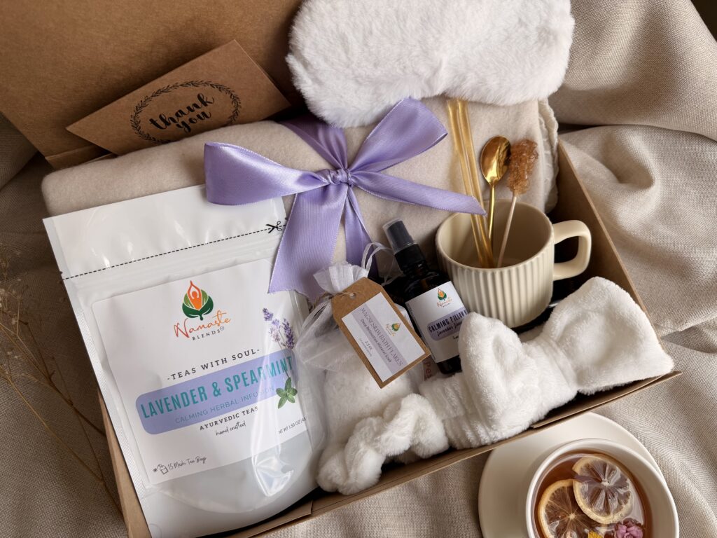 Serenity Ritual Gift Box featuring Lavender & Spearmint Herbal Tea, cozy blanket, plush eye mask, spa headband, magnesium bath flakes, calming pillow mist, ceramic tea mug, and self-care essentials by Namaste Blends.