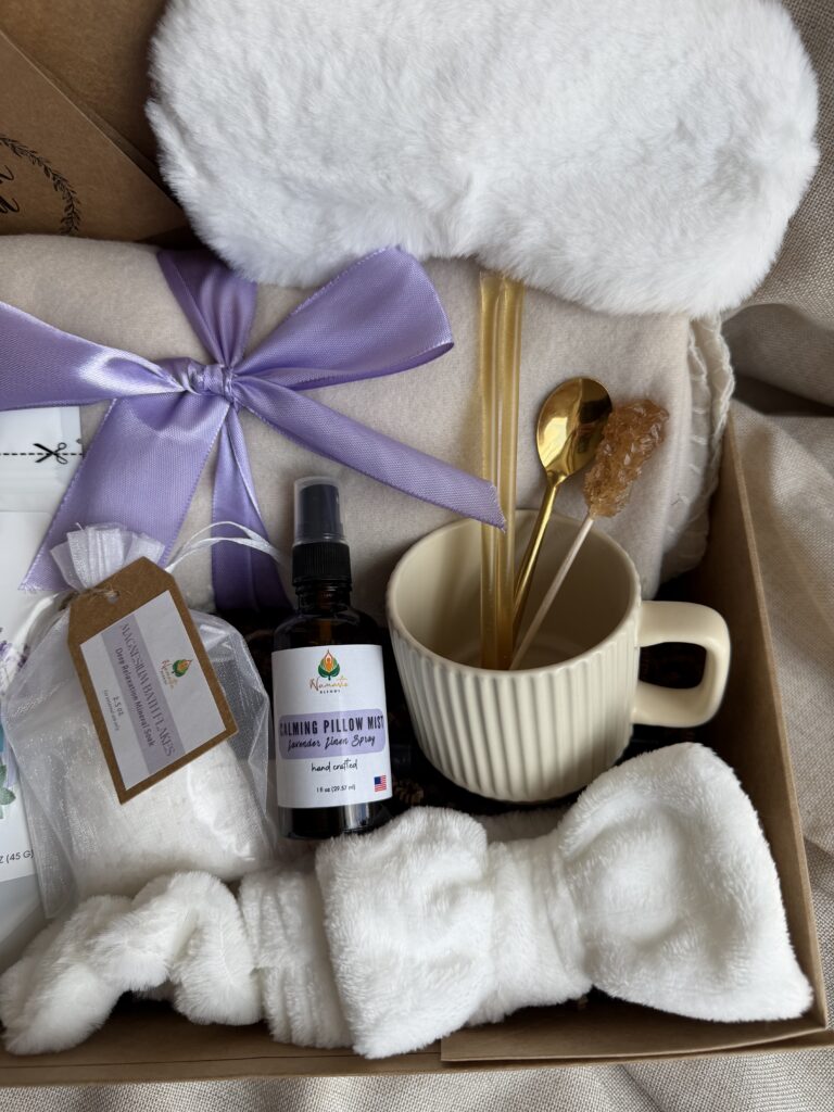 Serenity Ritual Gift Box featuring Lavender & Spearmint Herbal Tea, cozy blanket, plush eye mask, spa headband, magnesium bath flakes, calming pillow mist, ceramic tea mug, and self-care essentials by Namaste Blends.