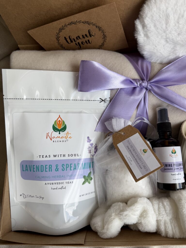 Serenity Ritual Gift Box featuring Lavender & Spearmint Herbal Tea, cozy blanket, plush eye mask, spa headband, magnesium bath flakes, calming pillow mist, ceramic tea mug, and self-care essentials by Namaste Blends.