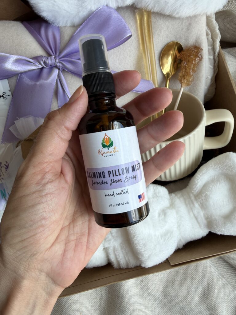 Serenity Ritual Gift Box featuring Lavender & Spearmint Herbal Tea, cozy blanket, plush eye mask, spa headband, magnesium bath flakes, calming pillow mist, ceramic tea mug, and self-care essentials by Namaste Blends.