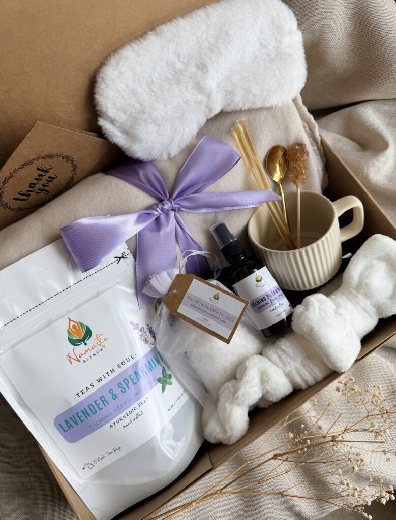 Serenity Ritual Gift Box featuring Lavender & Spearmint Herbal Tea, cozy blanket, plush eye mask, spa headband, magnesium bath flakes, calming pillow mist, ceramic tea mug, and self-care essentials by Namaste Blends.