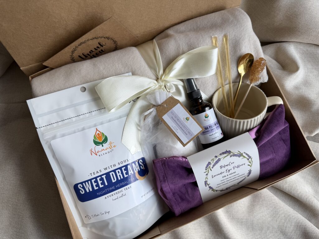 The Sweet Dreams Ritual Box is a luxurious bedtime gift designed to inspire peaceful evenings and comforting self-care rituals. Featuring our handcrafted Sweet Dreams Herbal Tea, a soft throw blanket, lavender eye pillow, magnesium bath flakes, calming pillow mist, ceramic tea mug, gold spoon, honey stick, and sugar stick, this beautifully curated collection creates the perfect nighttime tea experience. This premium gift set includes 15 food-grade mesh tea bags filled with our naturally caffeine-free botanical blend, handcrafted in small batches by Namaste Blends. Beautifully packaged and ready to gift, it's the perfect choice for birthdays, Mother's Day, holidays, thank-you gifts, or anyone who enjoys cozy evenings, botanical teas, and intentional bedtime rituals.